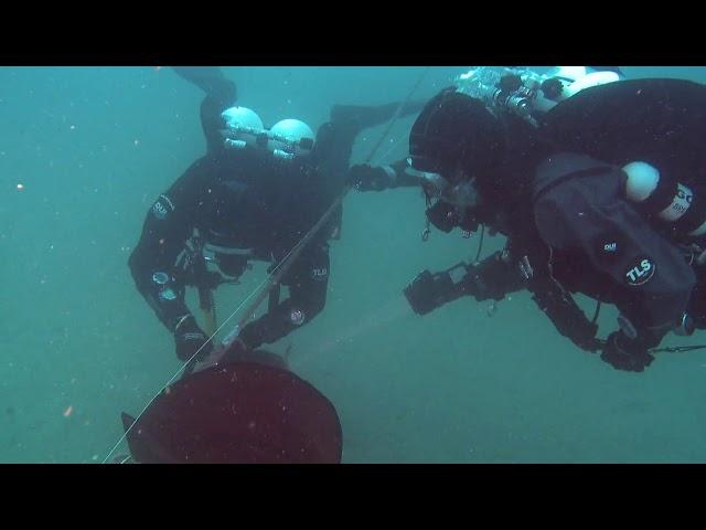 Divers exploring under water at the dogger bank in the sea 