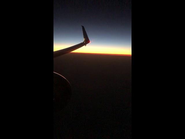 Sunset Sky From Airplane Window. Sunset Over North Pacific Ocean. Sunset on the Horizon.