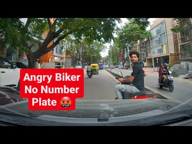 Angry biker stops car on the middle of the road