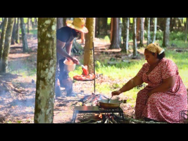 cooking a traditional meal outside on the fire