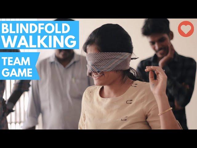 Employees playing blindfold game to build team spirit