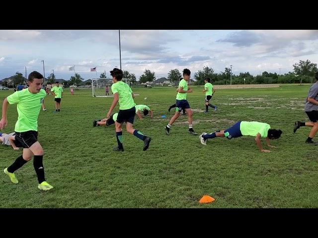 Alex showing his team mates how to do a push up.