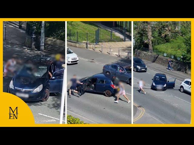 Moment fight breaks out between motorists on main road