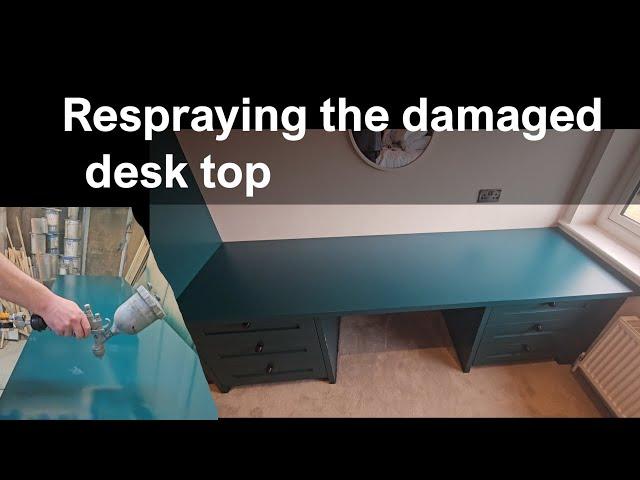 Respraying the damaged desk top with PU enamel paint.