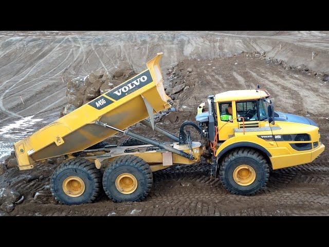 Volvo A45G articulated haulers dumping rock- D8T Dozer pushing away