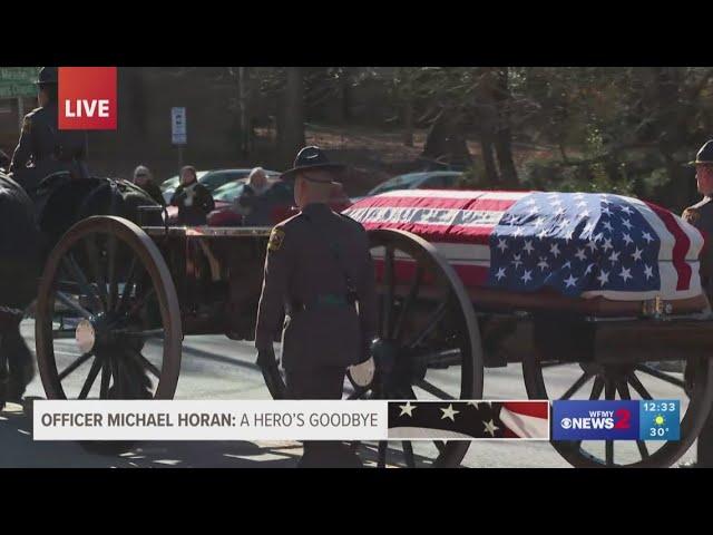 Horse-drawn caisson carries Officer Michael Horan to funeral service