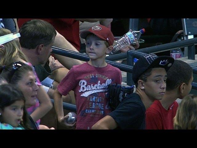 Kid misses ball, another gives him souvenir