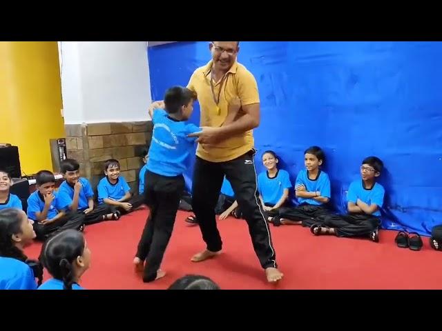 Watch as our dedicated teacher empowers students with essential self-defense skills! 