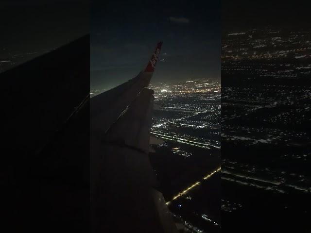 Beautiful view over Bangkok at night: approach and landing at Don Mueang Airport