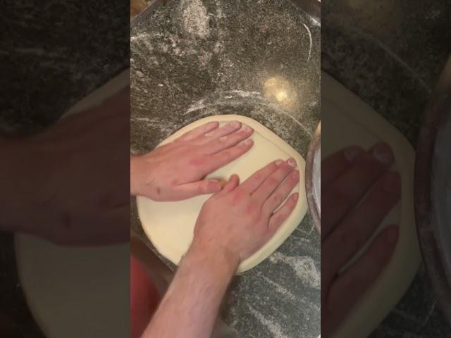 Stretching a perfectly round pizza dough!