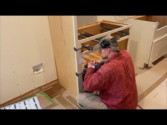 Episode 222: Kitchen cabinets: installing the refrigerator side panels and the first base cabinet!