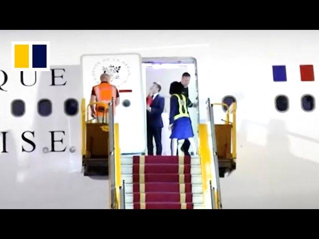 Macron’s wife appears to push French president’s face