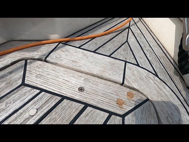 Typical periodic teak deck maintenance on a Hallberg Rassy, replacing bungs.