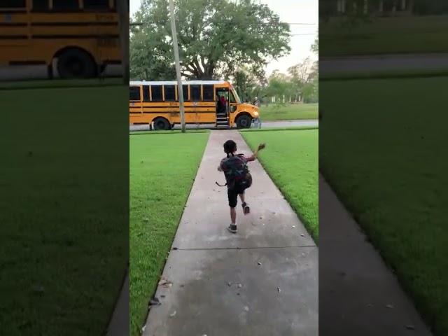 Little Boy Falls Onto Grass While Running to Catch School Bus