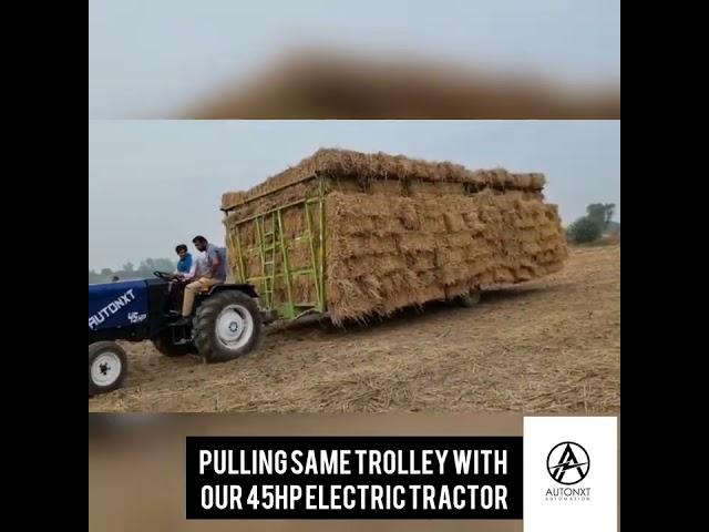 AutoNxt - 45HP Electric Tractor pulling heavy load through uneven farmland, on slope and on road.