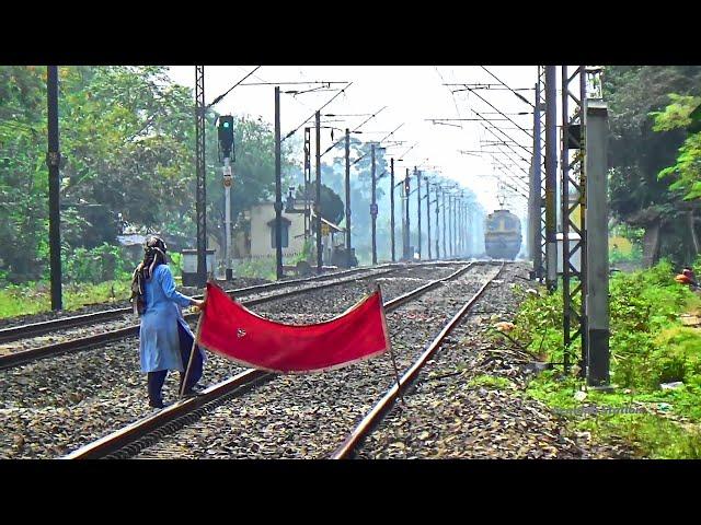 Lady Gangman showing Red signal to Sealdah-Ranaghat Memu special passenger Train