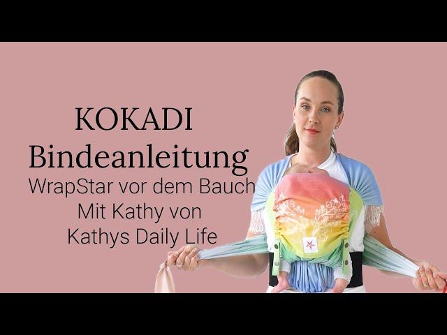 Babytrage Anleitung KOKADI WrapStar vorne auf dem Bauch getragen (Half Buckle / Tragetuchstoff)