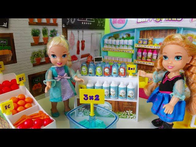 Elsa and Anna toddlers go shopping at the supermarket and buy toys