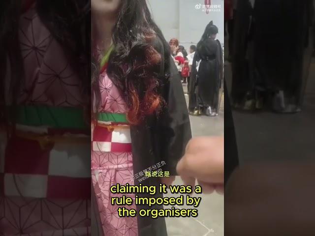 at a convention in china, cosplayer is removed because it is forbidden to wear kimono, because it is