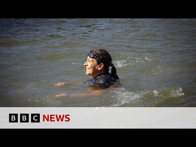 Paris mayor swims in Seine to prove water clean enough for Olympics | BBC News