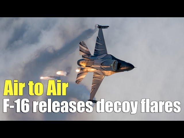 Air to Air:F-16 rolls and releases decoy flares