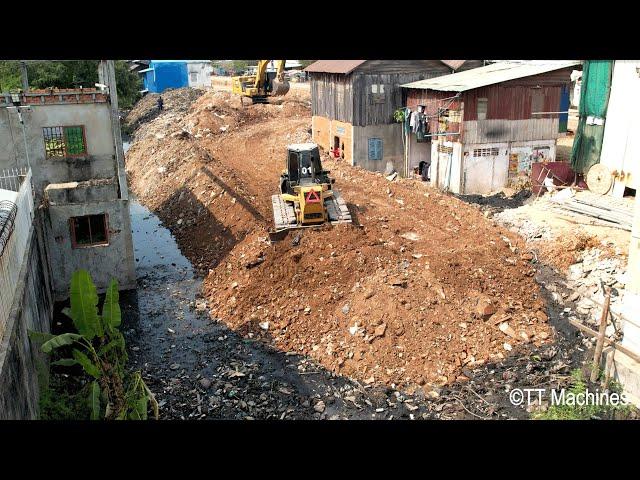 Updating Project In Village By Bulldozer & Excavator Clearing Trash Rock Into Water With Dump Trucks