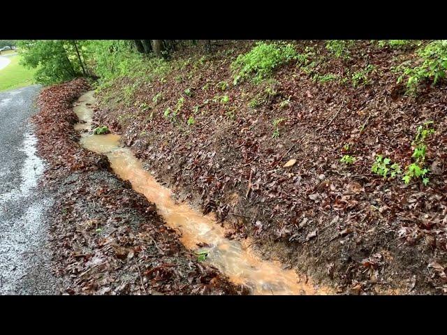 Mucking out a driveway drainage ditch