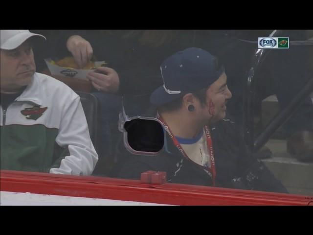 Wild player shoots puck through hole in glass, hits photographer