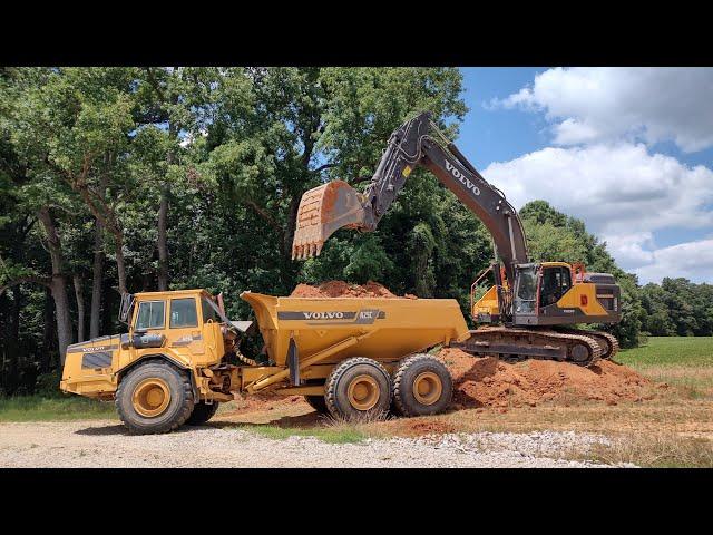 Hauling And Spreading Dirt Around The Shop Preparing For Stone