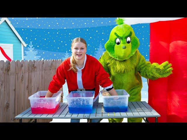 Assistant Helps Santa and the Grinch Make Green Slime in Holiday Town