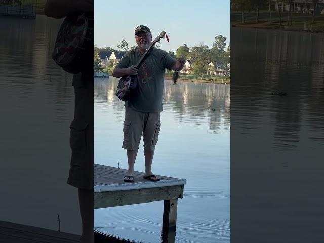 Man Reels in Fish With Banjo