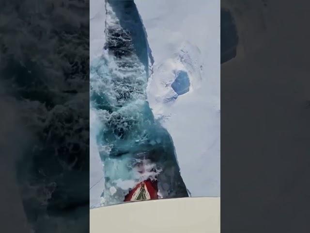 Ice breaker ship clearing way for a container ship