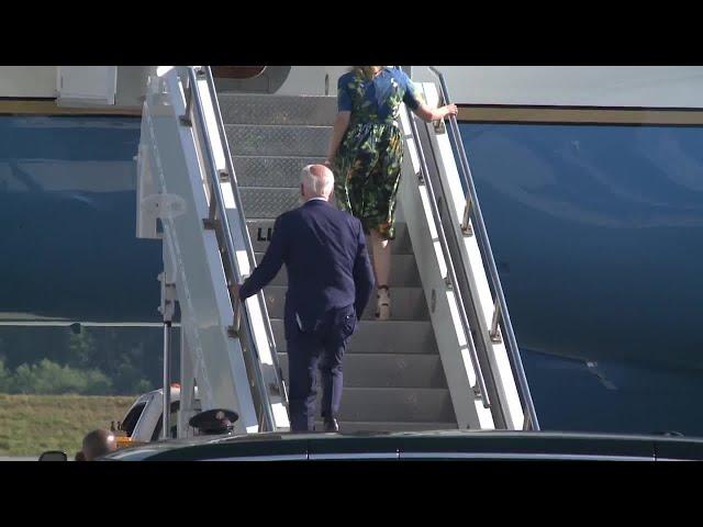President Joe Biden climbs steps to Air Force One at HIA