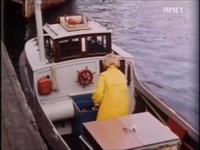 Woman in a yellow raincoat on a boat