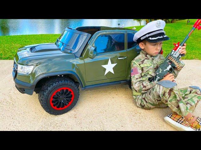 Senya plays with the military car