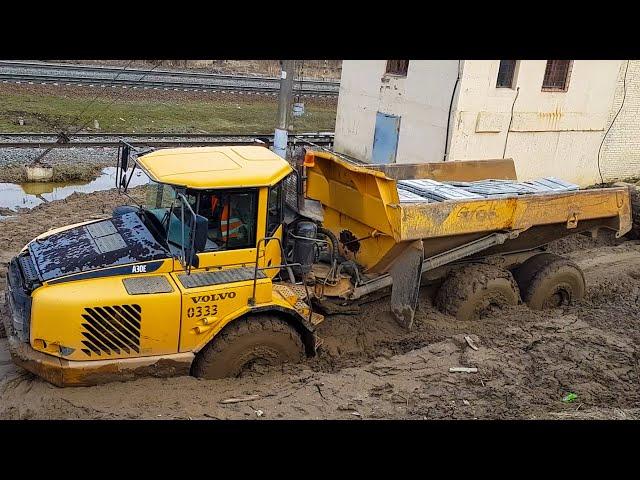 Cargo transportation off-road in dirt. Trucks work at the limit of their capabilities.