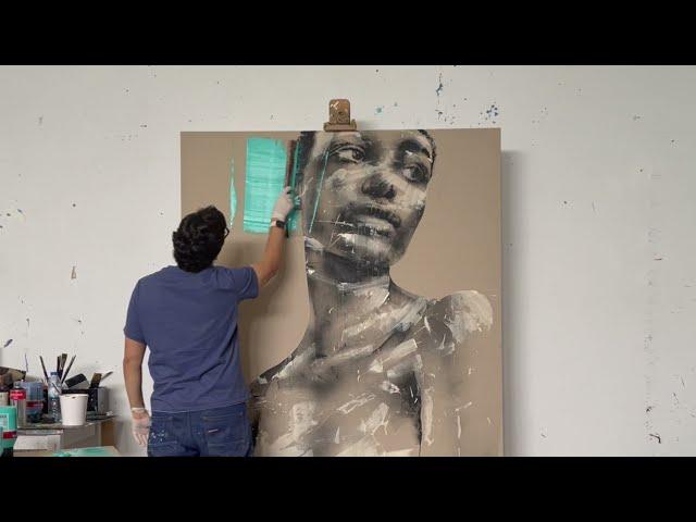 Mario Henrique painting in his studio