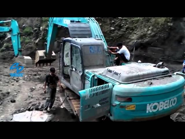 Excavator Kobelco Stuck after being hit by volcanic material