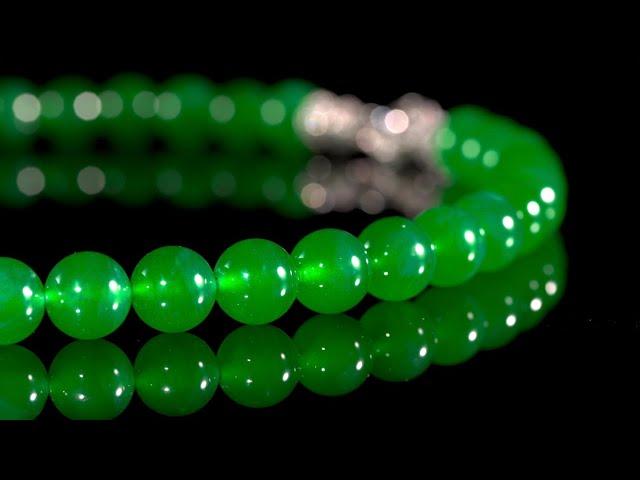 An Extraordinary 'Imperial Green' Jadeite Bead and Diamond Necklace