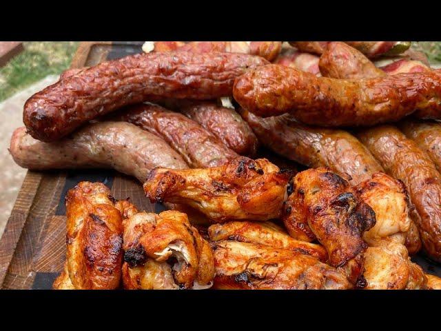 Chicken wings and sausages on grills el barril