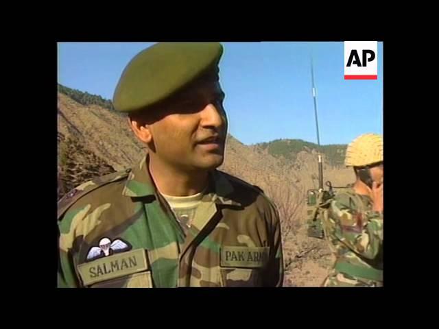 Soldiers at Line of Control + damaged villages