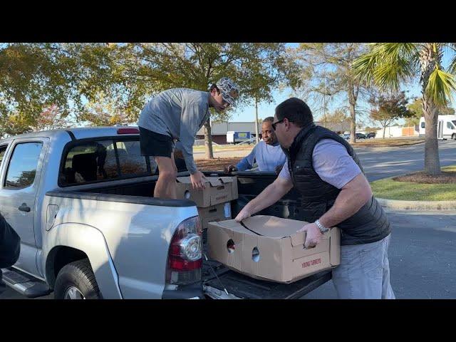 Attorney David Marshall and young helpers load 30 frozen donated turkeys for Orangeburg's Samaritan