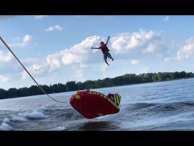 Kid ejected off tube behind surf boat (slow motion)