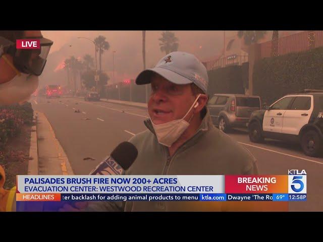 Actor Steve Guttenberg helping fire crews by moving cars near Pacific Palisades brush fire