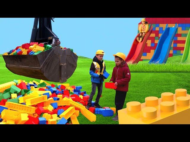 The kids build a Lego tower with a real construction vehicle ‍‍
