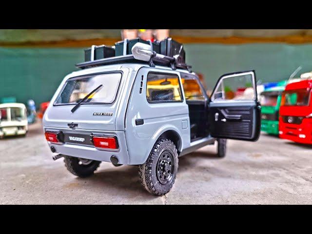 The Lada Niva car is driving off-road! Scale model 1/18. About cars