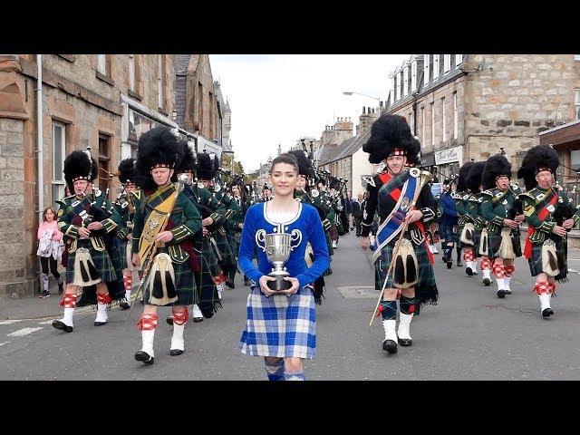 Drum Majors flourish during Huntly Pipe Band's 70th anniversary parade , Scotland, Sept' 2018