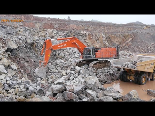 Hitachi 870 LCH excavator loading rock in a quarry.