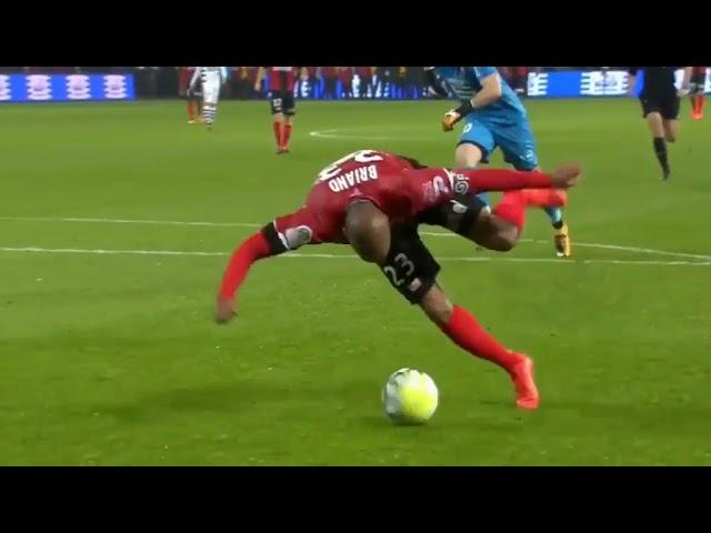 Guingamp's Jimmy Briand tries to score off-balance against rennes fc