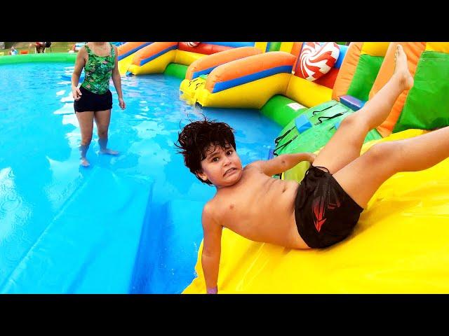 Kai and Clara Play at Water Park and Inflatable Toys. Kai The King of Water Slides